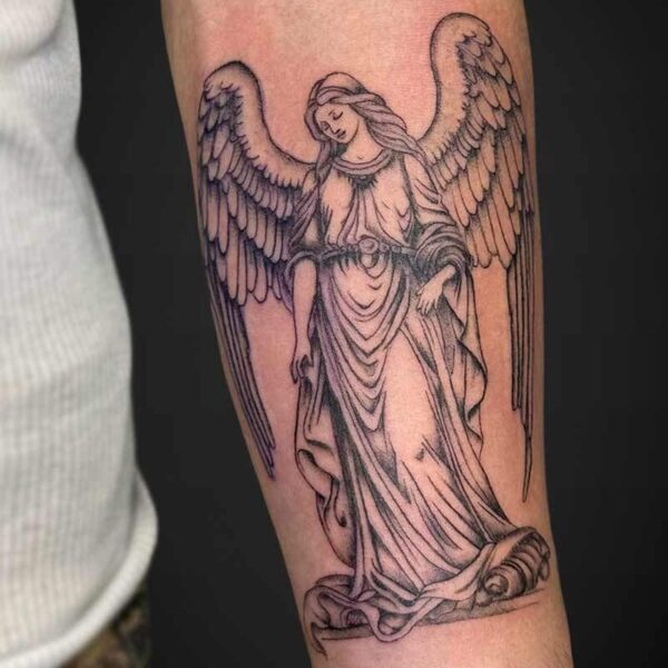 Tattoo of a kneeling angel with large spread wings on a forearm, standing on a cloud-like base.