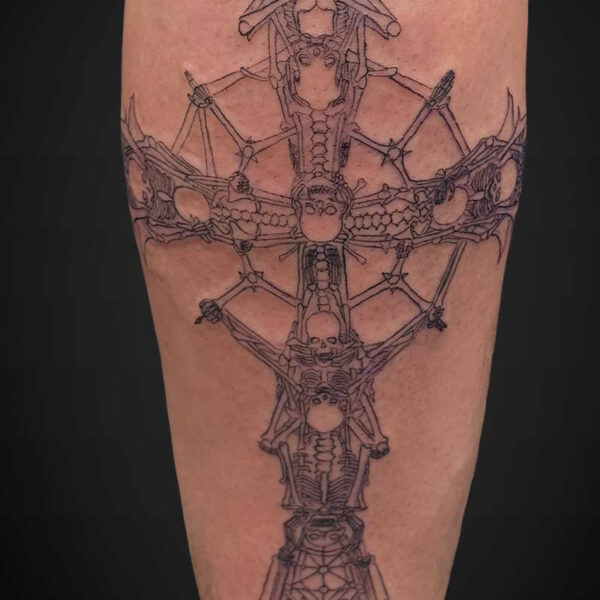 Vertical leg tattoo featuring interconnected skeletal figures and skull motifs forming a symmetrical, cross-like spine design.