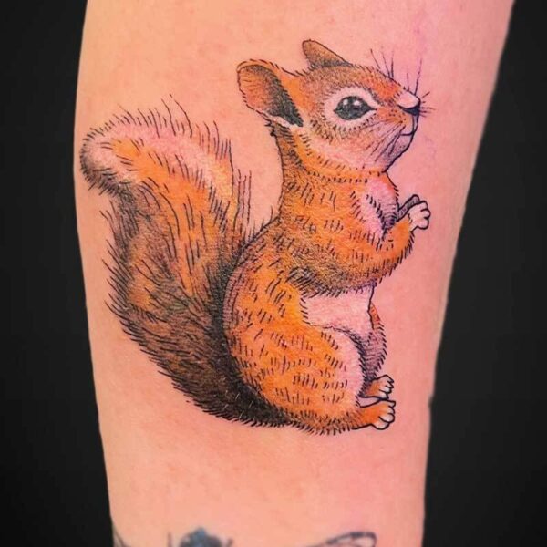 Colorful tattoo of a seated orange-brown squirrel with a fluffy tail on a forearm, facing right.