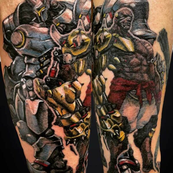 Colorful tattoo of two large armored robots on the calf, shown from front and side.