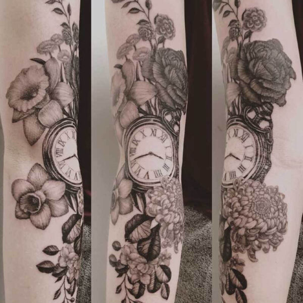 Forearm tattoo of a pocket watch surrounded by flowers and leaves, shown in three angles on pale skin.