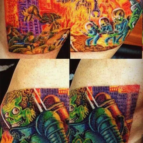 Vibrant full-sleeve tattoo showing a sci-fi battle with armored figures and a green creature across the forearm and upper arm area.