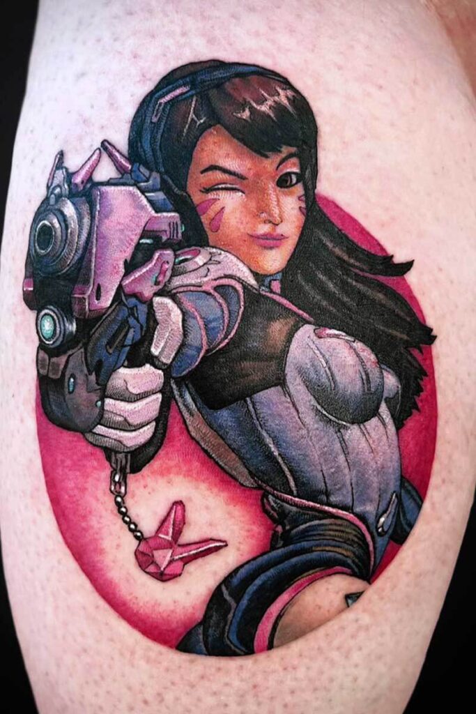 Colorful tattoo of a female character in futuristic armor, pointing a large gun toward the viewer with a wink, pink background.