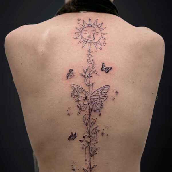 fineline-tattoo-butterflies-sun-moon Back view of person with a vertical tattoo featuring a sun with a face at the top, a flowering stem, and butterflies down the spine.