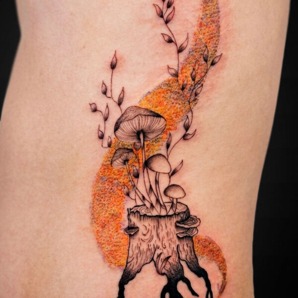 Tattoo on skin of a tree stump with mushrooms growing upward, entwined vines, and an orange curved backdrop behind them.