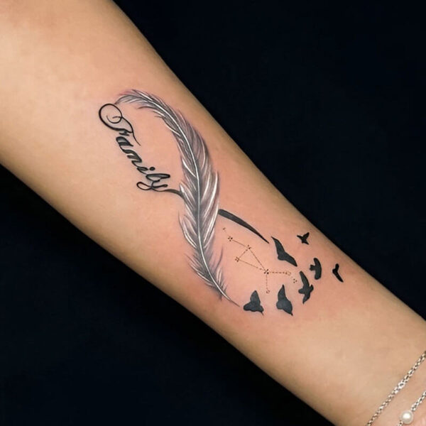Forearm tattoo: a curved feather with the name Grace in cursive, plus a flock of birds and a small constellation motif nearby.