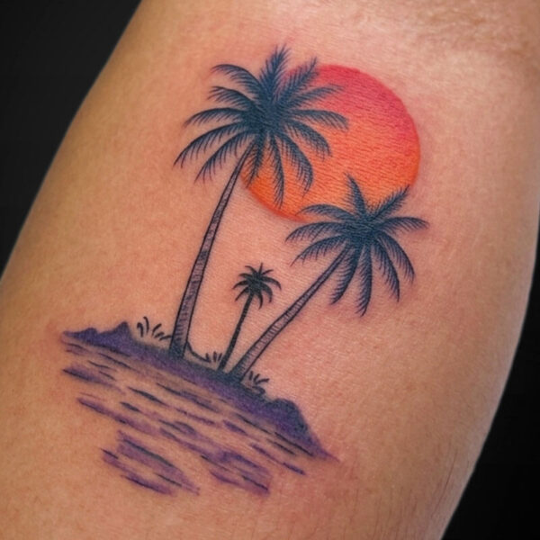 Tattoo of a tropical island with three palm trees, purple water, and an orange sunset behind them on the skin.