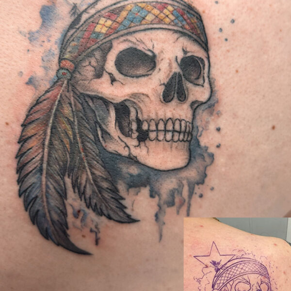 coverup-tattoo-skull-feather-band Color tattoo of a skull wearing a patterned headband, with a long feather and blue watercolor splash behind it.