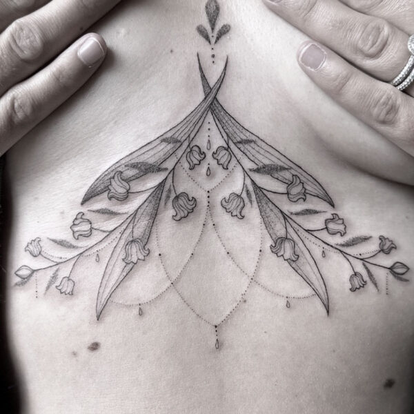 Delicate, symmetrical floral tattoo at the back of the neck with curved petals and hanging dot chains.