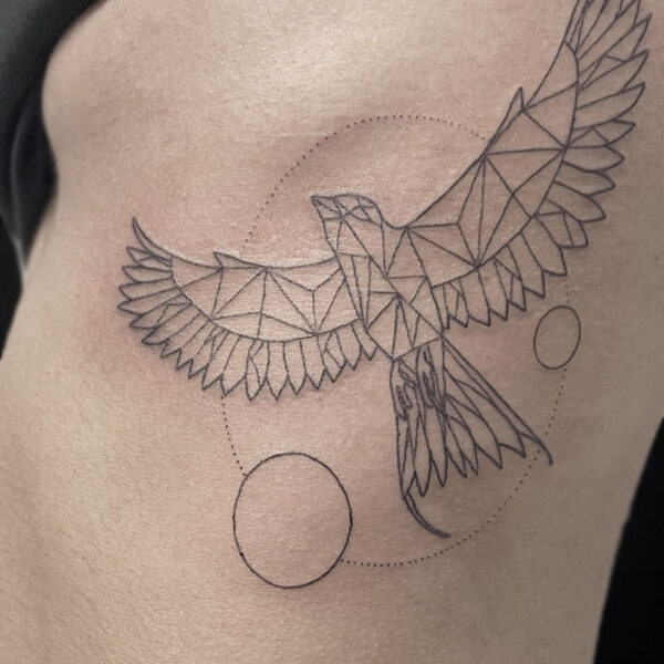 Geometric bird tattoo with wings spread, made of angular facets inside a dotted circle and solid circles nearby.