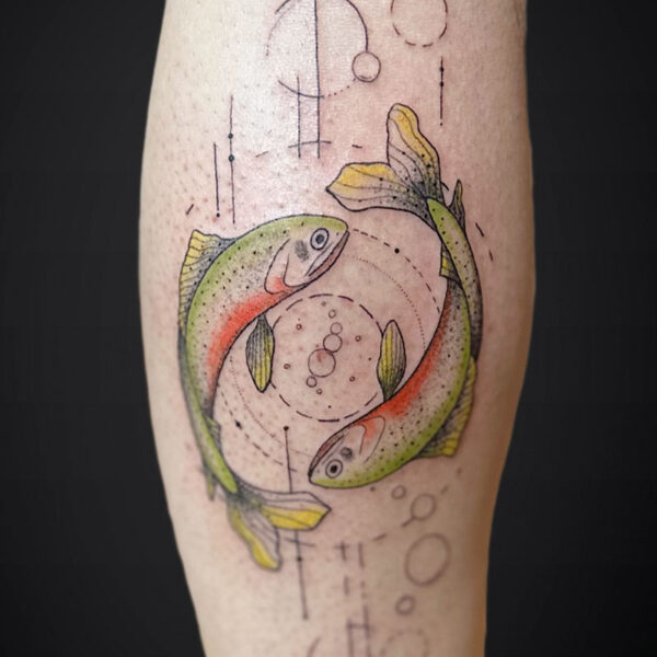 Colorful tattoo on forearm showing two koi-like fish circling with geometric lines and bubbles around them.
