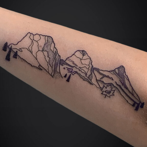 Forearm tattoo of a minimalist mountain range in black ink, with a small sunburst near the right end.