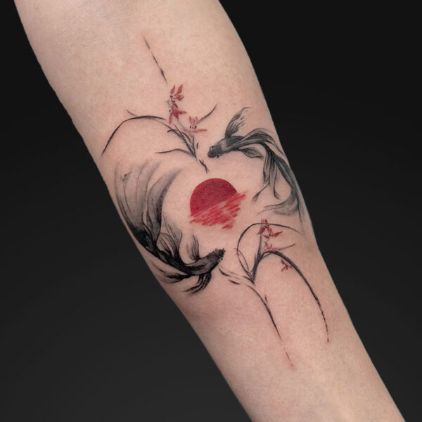 Forearm tattoo of a red sun with black flowing lines suggesting koi fish and delicate branches.