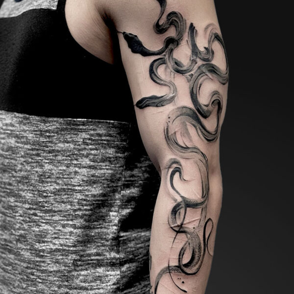 Abstract black tattoo sleeve with flowing, swirling ribbons along the upper to lower arm.