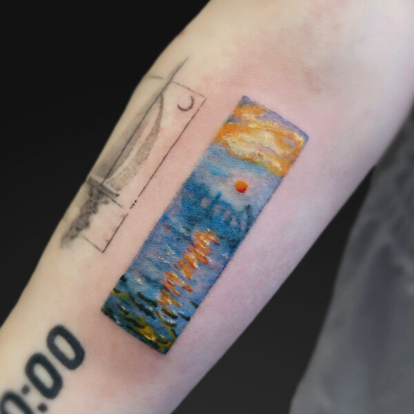 Forearm tattoo: a vertical rectangular watercolor scene of a sunset over the sea with blue water and orange sun, plus the word Hawaii, beside a rough black outline resembling a window.
