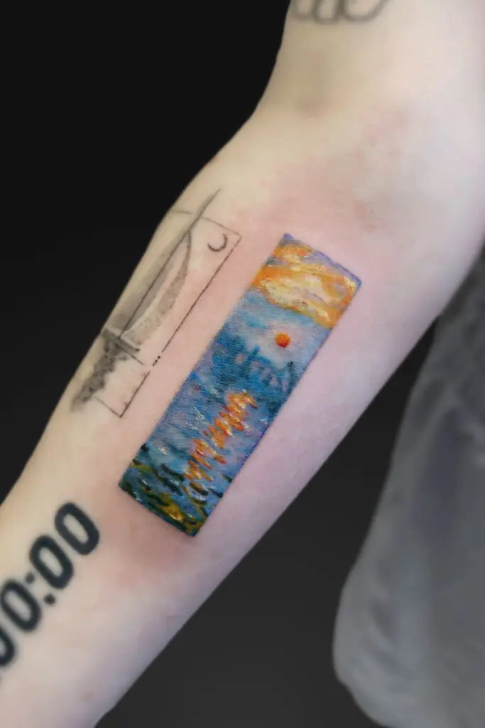 Forearm tattoo: a vertical rectangular watercolor scene of a sunset over the sea with blue water and orange sun, plus the word Hawaii, beside a rough black outline resembling a window.