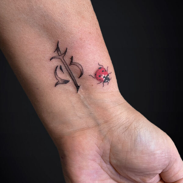 script-tattoo-with-realistic-ladybug script-tattoo-with-realistic-ladybug